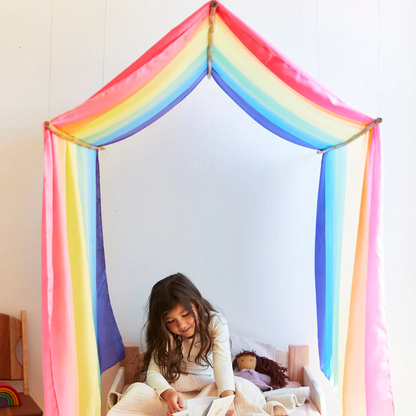 A child sitting inside a colorful canopy sarasilk